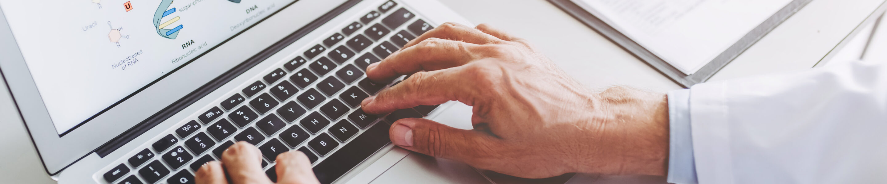 Cropped image of senior experienced scientist is working in laboratory. Doing investigations using laptop