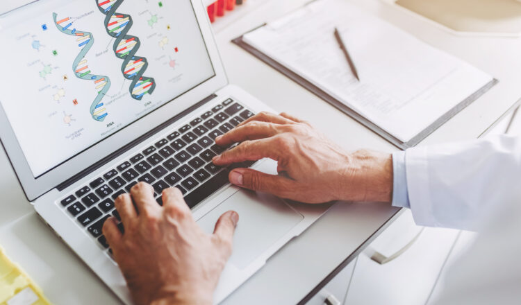 Cropped image of senior experienced scientist is working in laboratory. Doing investigations using laptop