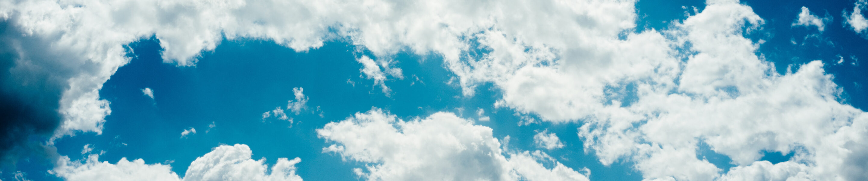 Blue sky background. Freedom hope dreams. White clouds. Sunny day.