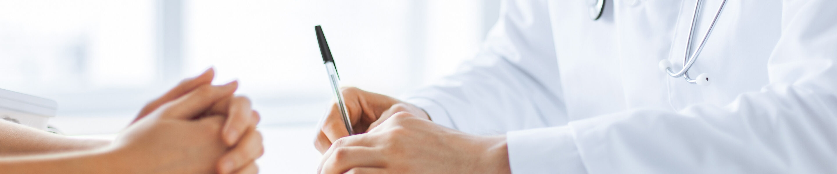 close up of patient and doctor taking notes