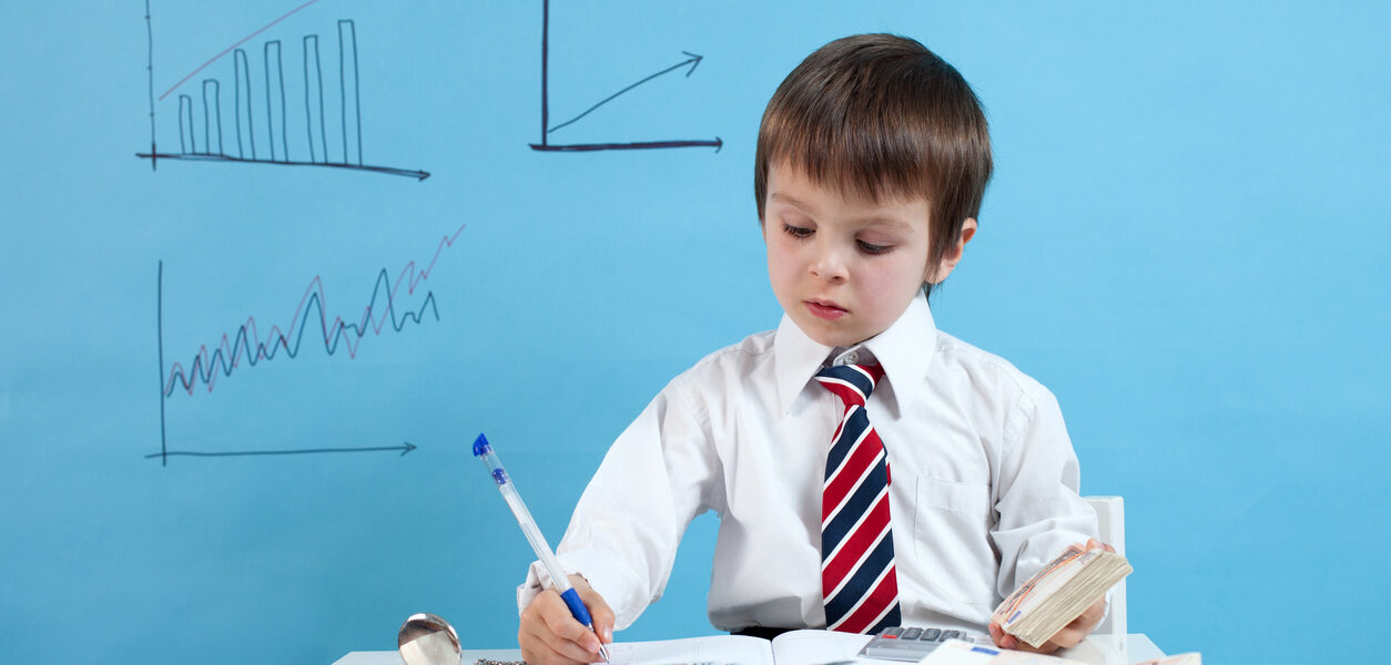 Young boy, counting money and taking notes