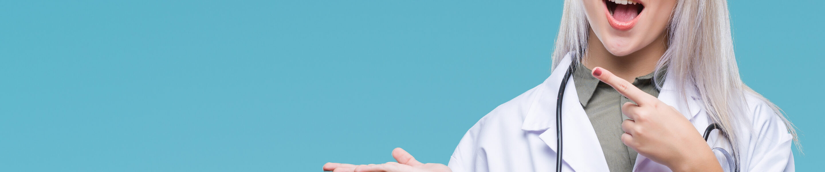 Young blonde doctor woman over isolated background amazed and smiling to the camera while presenting with hand and pointing with finger.