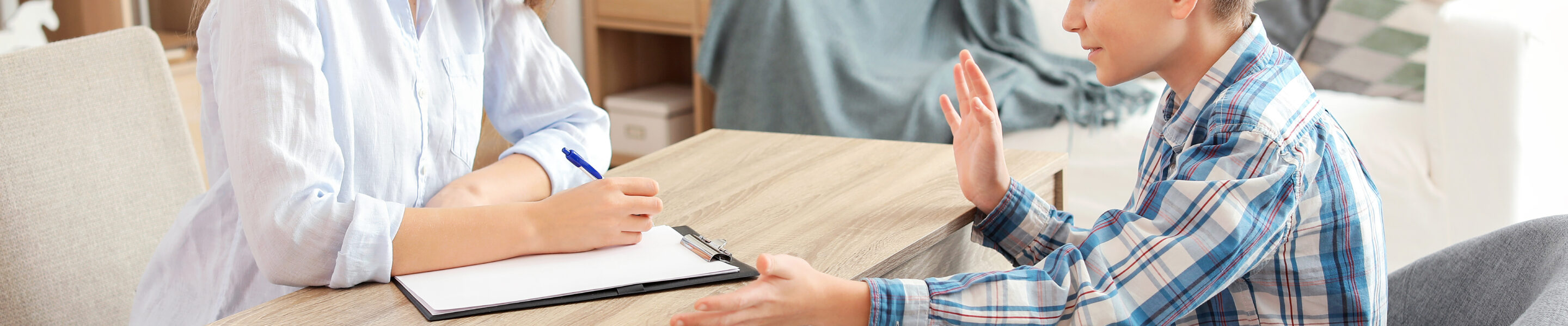 Female psychologist working with boy in office