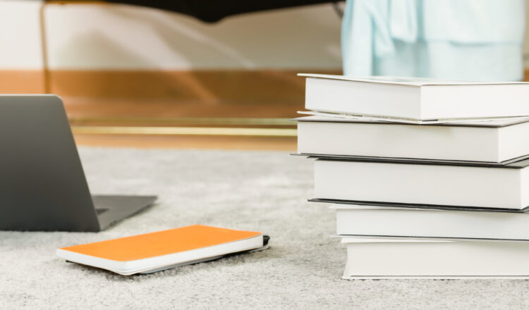 The education concept, Computers laptop, and books are placed on the carpet at home. proportion of the banner for ads.