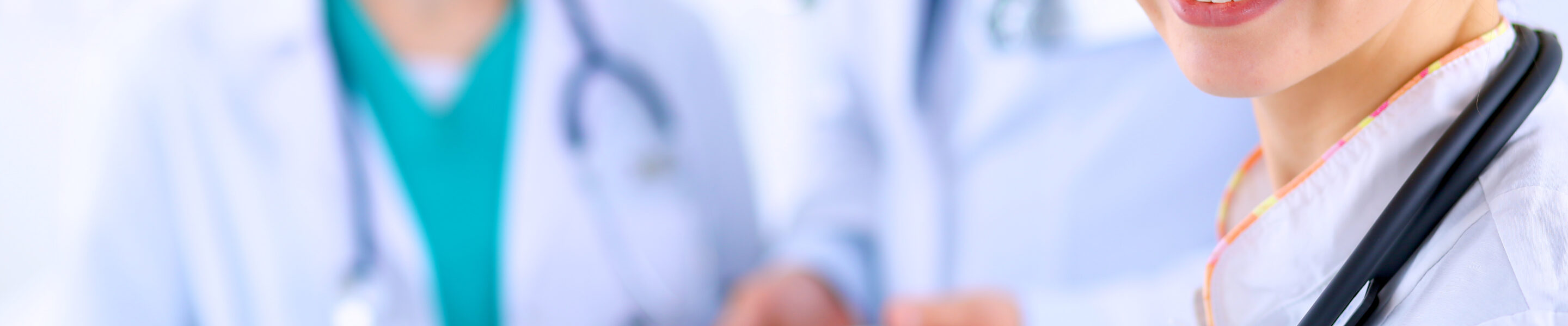 Attractive female doctor with folder in front of medical group .