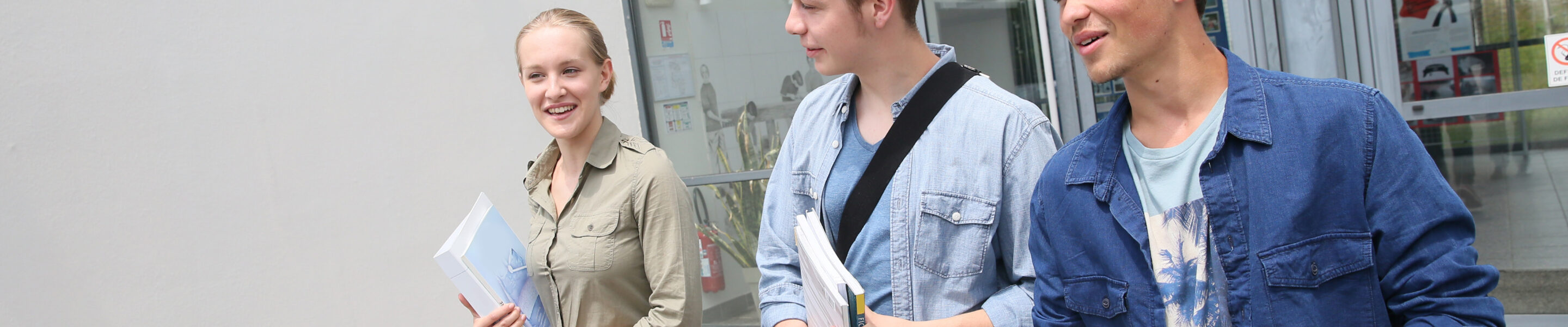 Young students walking outside campus building
