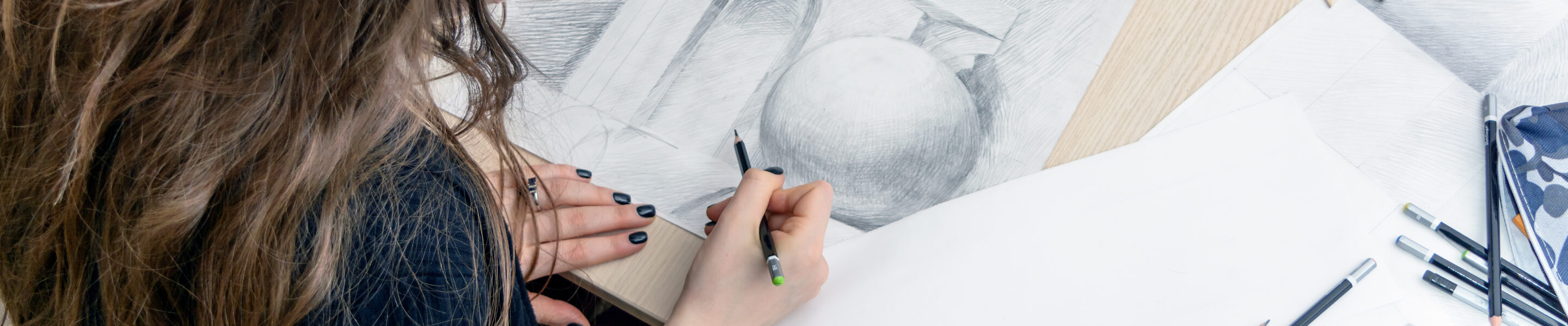 Top view of the female architect designer draws sketches in pencil on white paper. Black and white drawing of an architectural element