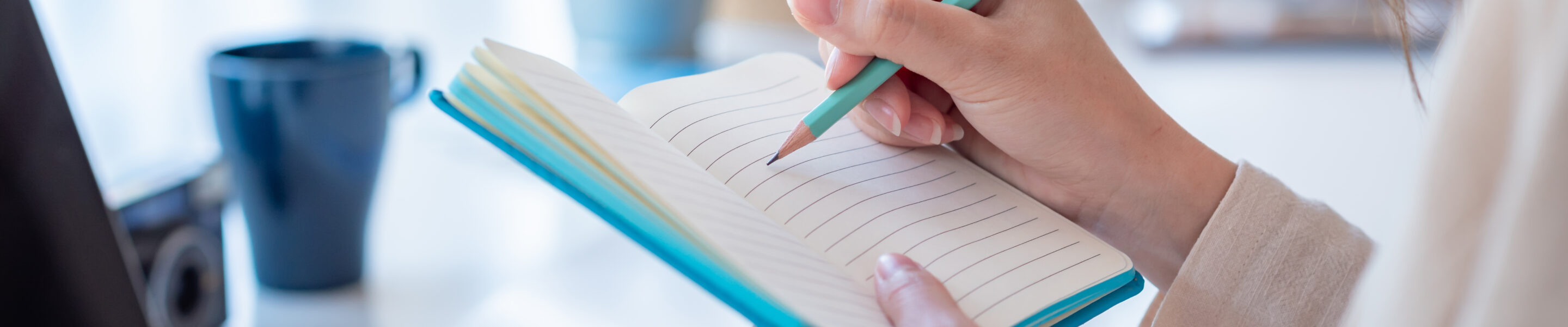 Woman colleg student who taking note online learning at home.