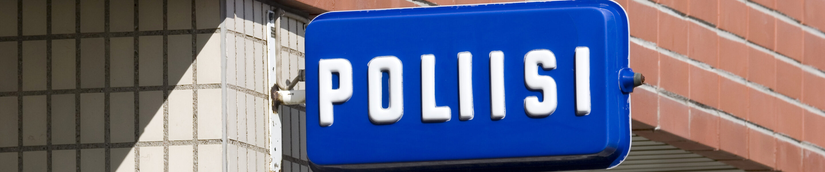 Finnish police sign on building wall, Finland Europe