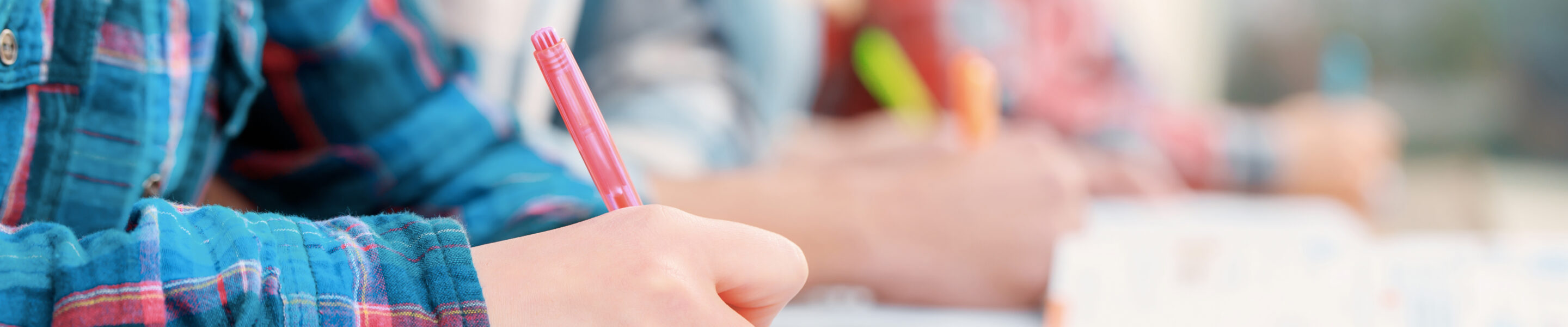 Exams. Cropped view of students writing a test in their exercise books