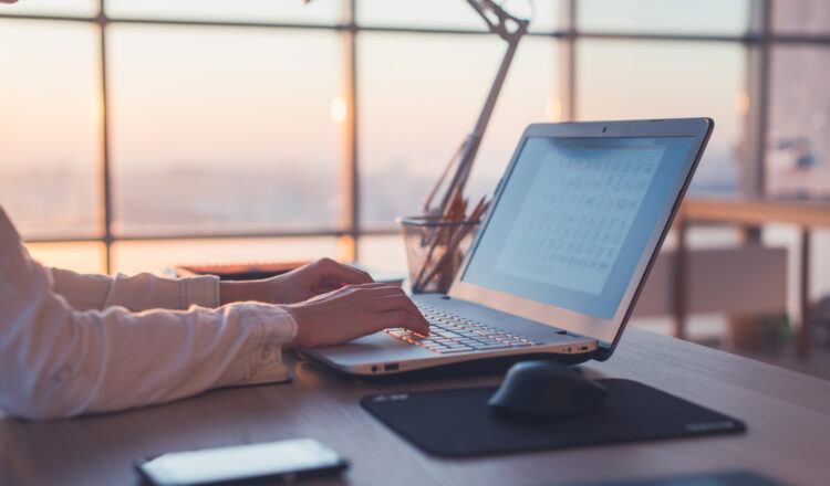 Adult businesswoman working at home using computer, studying business ideas on a pc screen on-line